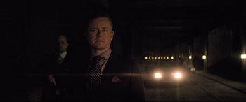 Movie still from “Mission: Impossible - Fallout” (2018), directed by Christopher McQuarrie – A man wearing a suit and tie standing in front of a street light; Close Up shot, Low angle