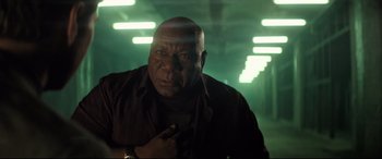 Movie still from “Mission: Impossible - Fallout” (2018), directed by Christopher McQuarrie – An older man in a dark room with green lighting; Close Up shot, Low angle