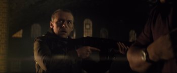 Movie still from “Mission: Impossible - Fallout” (2018), directed by Christopher McQuarrie – A man holding a gun while standing in a dark room; Medium shot, Low angle