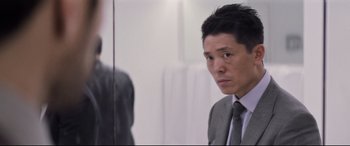 Movie still from “Mission: Impossible - Fallout” (2018), directed by Christopher McQuarrie – A man in a suit looking at himself in a mirror; Close Up shot, Over the shoulder angle