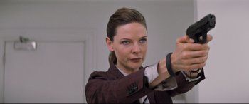 Movie still from “Mission: Impossible - Fallout” (2018), directed by Christopher McQuarrie – A beautiful woman in a brown jacket holding a smart watch; Close Up shot, Over the shoulder angle