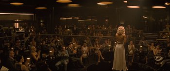 Movie still from “Mission: Impossible - Fallout” (2018), directed by Christopher McQuarrie – A group of people sitting in a room with lights; Wide shot, High angle