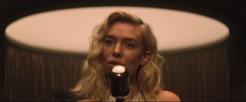 Movie still from “Mission: Impossible - Fallout” (2018), directed by Christopher McQuarrie – A woman with blonde hair is holding a microphone; Close Up shot, Low angle