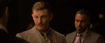 Movie still from “Mission: Impossible - Fallout” (2018), directed by Christopher McQuarrie – A person wearing a suit and tie; Close Up shot, Over the shoulder angle