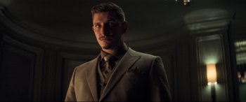 Movie still from “Mission: Impossible - Fallout” (2018), directed by Christopher McQuarrie – A man wearing a suit and tie in a room; Close Up shot, Low angle