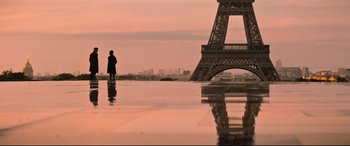 Movie still from “Mission: Impossible - Fallout” (2018), directed by Christopher McQuarrie – A person standing in front of a tower with a city skyline in the background; Extreme Wide shot, Low angle
