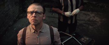 Movie still from “Mission: Impossible - Fallout” (2018), directed by Christopher McQuarrie – A man wearing glasses and a brown shirt; Close Up shot, Low angle