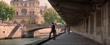 Movie still from “Mission: Impossible - Fallout” (2018), directed by Christopher McQuarrie – A couple kissing under a bridge in a city; Extreme Wide shot, High angle