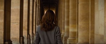 Movie still from “Mission: Impossible - Fallout” (2018), directed by Christopher McQuarrie – A woman walking down a hallway in a building; Medium shot, Low angle