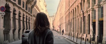 Movie still from “Mission: Impossible - Fallout” (2018), directed by Christopher McQuarrie – A woman walking down the street in a city; Wide shot, Over the shoulder angle