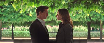 Movie still from “Mission: Impossible - Fallout” (2018), directed by Christopher McQuarrie – A man and a woman standing next to each other in front of a tree; Medium shot, Over the shoulder angle