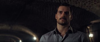 Movie still from “Mission: Impossible - Fallout” (2018), directed by Christopher McQuarrie – A person wearing a dress shirt; Close Up shot, Over the shoulder angle