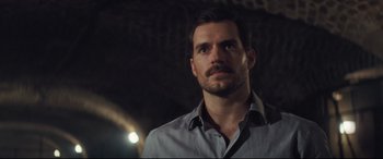 Movie still from “Mission: Impossible - Fallout” (2018), directed by Christopher McQuarrie – A person wearing a dress shirt; Close Up shot, Over the shoulder angle