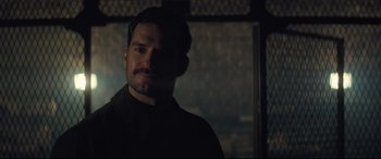 Movie still from “Mission: Impossible - Fallout” (2018), directed by Christopher McQuarrie – A person in a dark room; Close Up shot, Over the shoulder angle