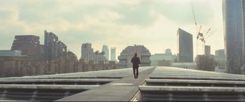 Movie still from “Mission: Impossible - Fallout” (2018), directed by Christopher McQuarrie – A man is walking down a walkway in a city; Extreme Wide shot, Low angle