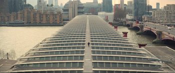 Movie still from “Mission: Impossible - Fallout” (2018), directed by Christopher McQuarrie – A person walking on a bridge near a body of water; Extreme Wide shot, High angle