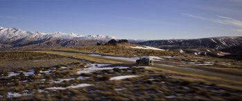 Movie still from “Mission: Impossible - Fallout” (2018), directed by Christopher McQuarrie – A truck driving down a road in the middle of a snowy field; Extreme Wide shot, High angle