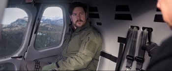 Movie still from “Mission: Impossible - Fallout” (2018), directed by Christopher McQuarrie – A man sitting in the back of a helicopter; Medium shot, High angle