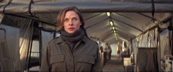 Movie still from “Mission: Impossible - Fallout” (2018), directed by Christopher McQuarrie – A woman wearing a jacket and a neck scarf; Close Up shot, Low angle