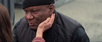 Movie still from “Mission: Impossible - Fallout” (2018), directed by Christopher McQuarrie – An older black man with his hand near his ear; Close Up shot, High angle