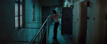 Movie still from “Mission: Impossible - Ghost Protocol” (2011), directed by Brad Bird – A person standing in a room with a railing; Wide shot, Low angle