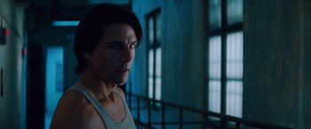Movie still from “Mission: Impossible - Ghost Protocol” (2011), directed by Brad Bird – A person wearing a tank top near a window; Close Up shot, Low angle