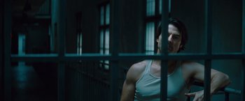Movie still from “Mission: Impossible - Ghost Protocol” (2011), directed by Brad Bird – A man standing behind bars in a jail cell; Medium shot, Low angle
