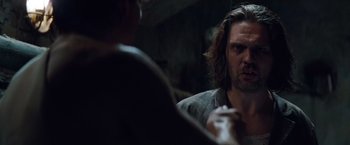 Movie still from “Mission: Impossible - Ghost Protocol” (2011), directed by Brad Bird – A man with long dark hair is looking at another man; Close Up shot, Over the shoulder angle