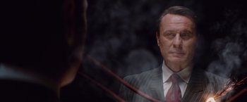 Movie still from “Mission: Impossible - Ghost Protocol” (2011), directed by Brad Bird – A man in a suit and tie looking at a mirror; Close Up shot, Over the shoulder angle