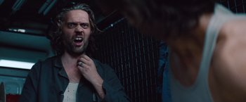 Movie still from “Mission: Impossible - Ghost Protocol” (2011), directed by Brad Bird – A man with long white hair and a beard is holding his mouth open; Close Up shot, Low angle