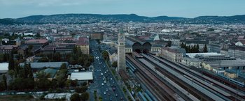 Movie still from “Mission: Impossible - Ghost Protocol” (2011), directed by Brad Bird – An aerial view of a train station with a clock tower in the foreground; Extreme Wide shot, High angle