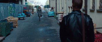 Movie still from “Mission: Impossible - Ghost Protocol” (2011), directed by Brad Bird – A woman walking down a street in a warehouse; Wide shot, Over the shoulder angle