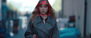 Movie still from “Mission: Impossible - Ghost Protocol” (2011), directed by Brad Bird – A woman with a red square on her face; Close Up shot, Over the shoulder angle