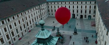Movie still from “Mission: Impossible - Ghost Protocol” (2011), directed by Brad Bird – A large red balloon floating in the air over a courtyard; Extreme Wide shot, High angle