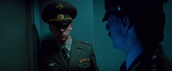 Movie still from “Mission: Impossible - Ghost Protocol” (2011), directed by Brad Bird – A man in a military uniform is looking at another man; Medium shot, Low angle