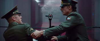 Movie still from “Mission: Impossible - Ghost Protocol” (2011), directed by Brad Bird – A man in a military uniform is holding a camera; Medium shot, Over the shoulder angle