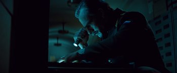 Movie still from “Mission: Impossible - Ghost Protocol” (2011), directed by Brad Bird – A man with a beard is using a flashlight; Close Up shot, Low angle