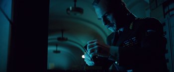 Movie still from “Mission: Impossible - Ghost Protocol” (2011), directed by Brad Bird – A man looking at a cell phone in a dark room; Close Up shot, Low angle
