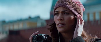 Movie still from “Mission: Impossible - Ghost Protocol” (2011), directed by Brad Bird – A person holding a camera near a building; Close Up shot, Low angle