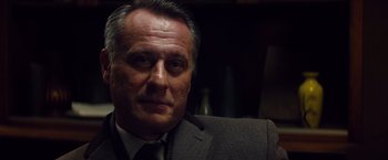 Movie still from “Mission: Impossible - Ghost Protocol” (2011), directed by Brad Bird – A person wearing a suit and tie; Close Up shot, Low angle
