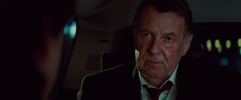 An older man wearing a suit and tie
