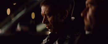 Movie still from “Mission: Impossible - Ghost Protocol” (2011), directed by Brad Bird – A person wearing a black jacket; Close Up shot, Over the shoulder angle