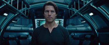 Movie still from “Mission: Impossible - Ghost Protocol” (2011), directed by Brad Bird – A man in a black t - shirt is looking at the camera; Close Up shot, Low angle