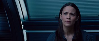 Movie still from “Mission: Impossible - Ghost Protocol” (2011), directed by Brad Bird – A woman with long black hair is looking into the distance; Close Up shot, Over the shoulder angle