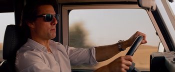 Movie still from “Mission: Impossible - Ghost Protocol” (2011), directed by Brad Bird – A man sitting in the driver's seat of a car; Close Up shot, Low angle