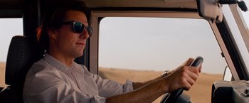 Movie still from “Mission: Impossible - Ghost Protocol” (2011), directed by Brad Bird – A man driving a car on a road; Close Up shot, Low angle