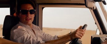 Movie still from “Mission: Impossible - Ghost Protocol” (2011), directed by Brad Bird – A man driving a car on a desert road; Close Up shot, Over the shoulder angle