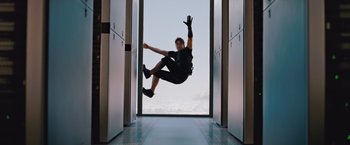 Movie still from “Mission: Impossible - Ghost Protocol” (2011), directed by Brad Bird – A man jumping in the air in front of a window; Wide shot, Low angle