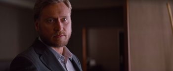 Movie still from “Mission: Impossible - Ghost Protocol” (2011), directed by Brad Bird – A person wearing a suit and tie; Close Up shot, Over the shoulder angle