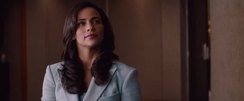 Movie still from “Mission: Impossible - Ghost Protocol” (2011), directed by Brad Bird – A woman in a blue suit looking to her left; Close Up shot, Over the shoulder angle